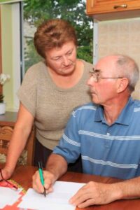 Couple reviewing insurance documents at home related to flood elevation survey in Tampa


