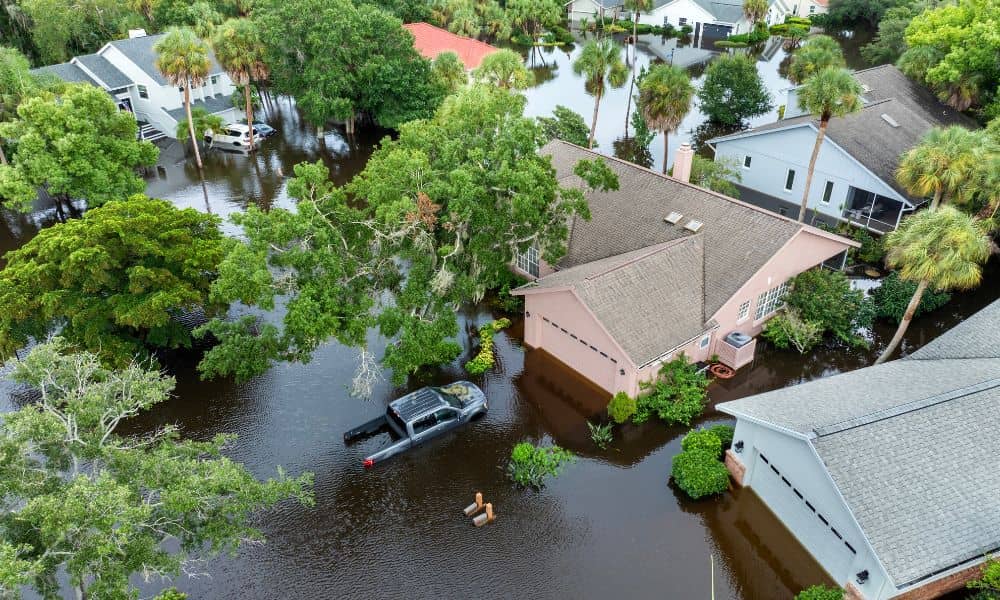 Aerial view of flooded residential homes showing how a boundary survey helps identify property lines in flood-prone areas
