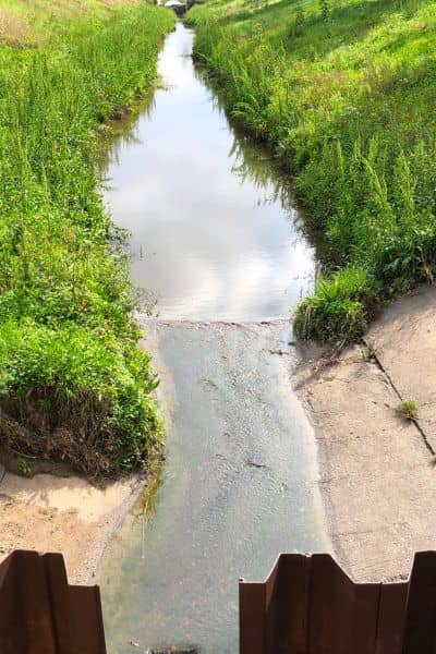 Drainage channel surveyed and designed by licensed land surveyors to control stormwater flow and prevent flooding