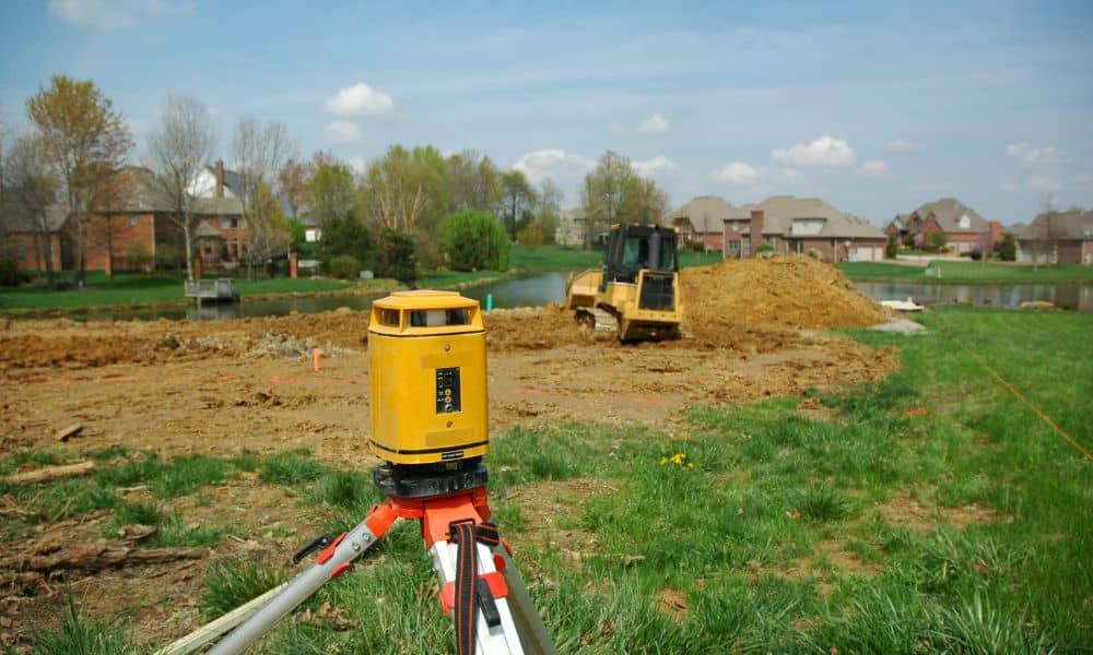 Construction survey equipment set up on a residential building site to check structure placement and land levels