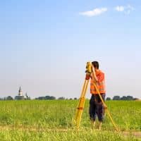 Surveyor collecting elevation data for a flood elevation certificate
