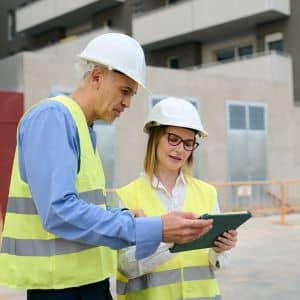 Licensed land surveyors reviewing property records during a boundary line survey to clarify land ownership
