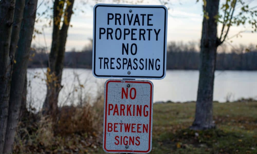 Private property no trespassing sign during a public vs private land dispute where a boundary line survey is often required