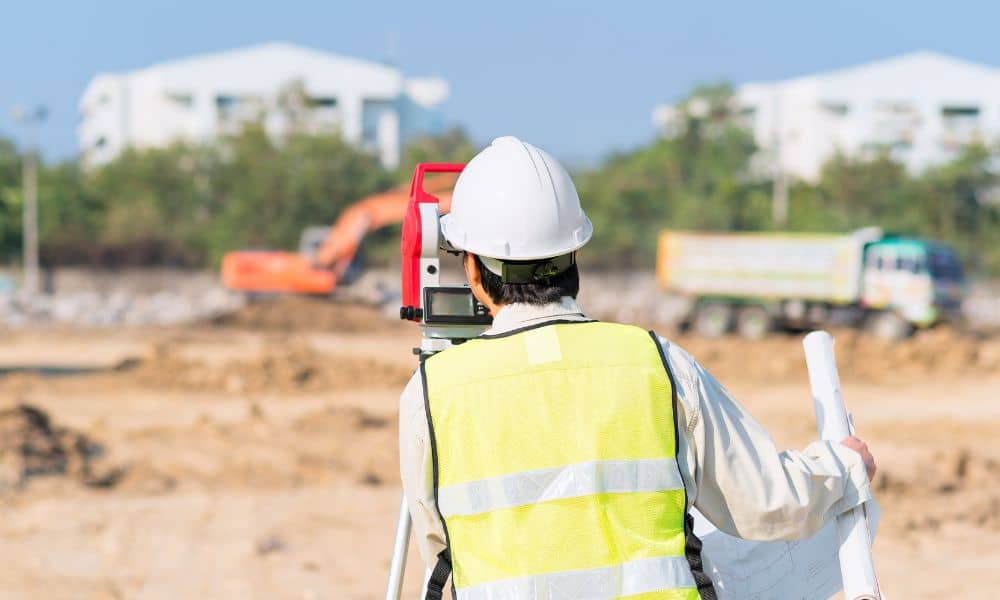 Land surveyor reviewing a commercial property site during an ALTA survey before development