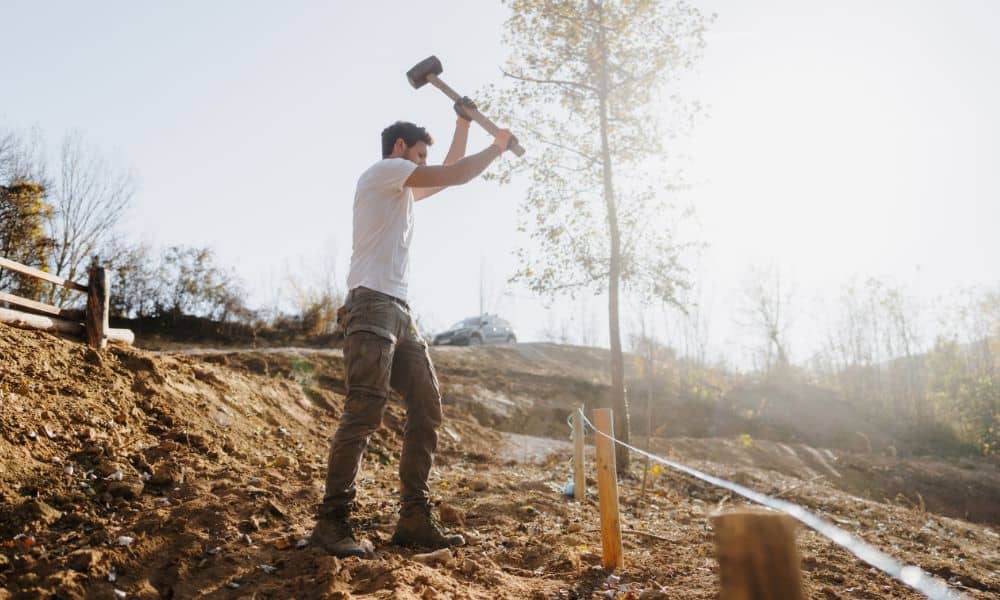 Survey stakes fence layout - ALTA SURVEY Tampa Person placing stakes to mark property boundaries before building a fence on a residential lot survey