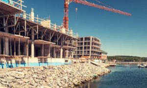 Waterfront construction project - ALTA SURVEY Tampa Licensed surveyor reviewing waterfront construction site near shoreline for permit approval