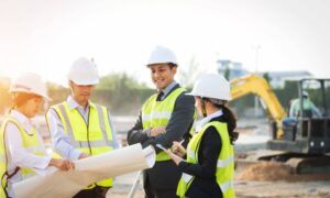 Team reviewing site plans together on a construction site before submission